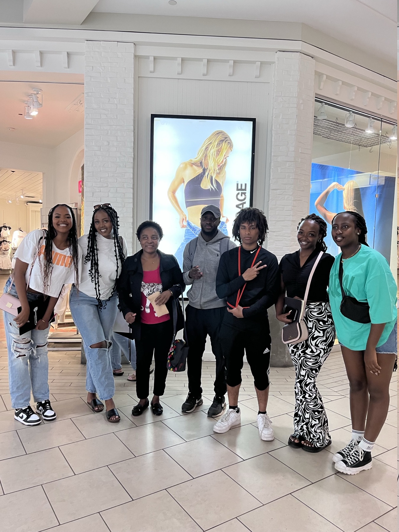 A group of ANZA participants standing together inside a shopping centre